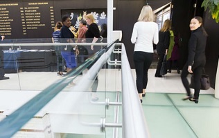 People standing and walking along a corridor