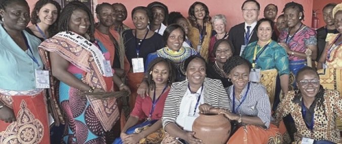 A group of people in coloured clothing smiling