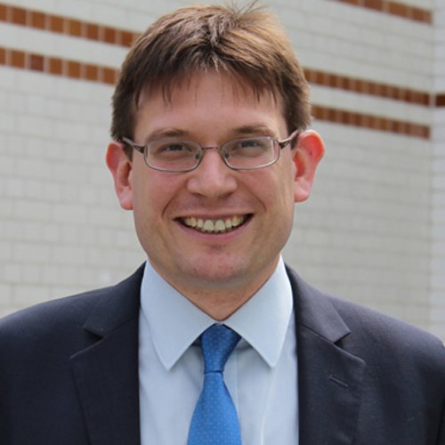 A square head and shoulders photograph of RCGP Executive Mark Thomas wearing a suit and blue tie.