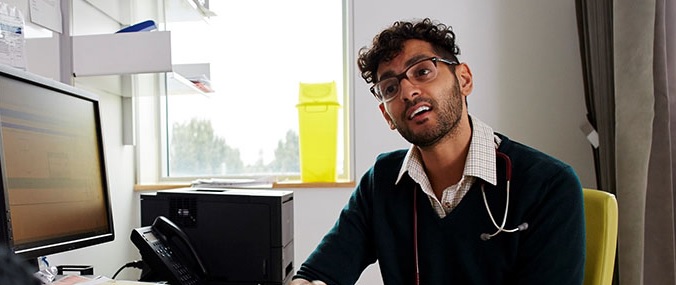A doctor talking to a patient in a consultation room