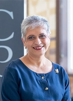 A small card image of Professor Kamila Hawthorne standing by a large RCGP sign.